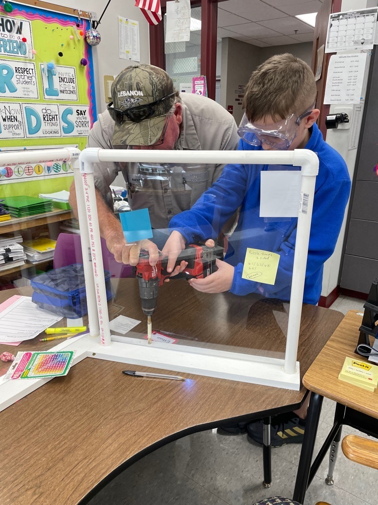 Using a power drill to add pencil holders to partitions!